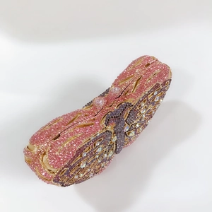 Detailed view of luxury evening bag with pink and purple gradient crystals and gold frame