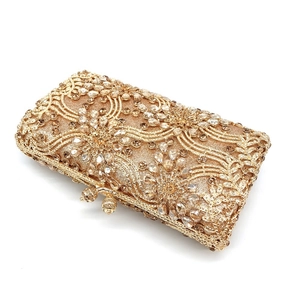 Exquisite close-up of champagne gold clutch with floral crystal and rhinestone patterns