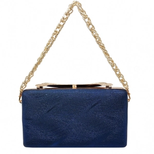 Detail of blue textured evening clutch featuring gold metal frame and thick chain handle