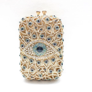 Makroaufnahme der Evil Eye Abendtasche mit goldener Metallhülle und Strasssteinen