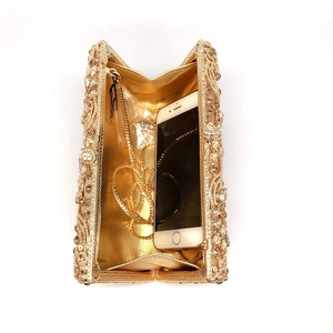 Sparkling gold diamond evening clutch bag with metal chain strap and luxury rhinestone finish