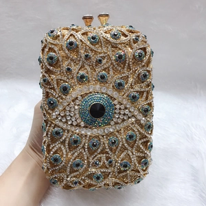Makroaufnahme von Goldrahmen und Kristallen auf der Luxus-Abendtasche mit Evil-Eye