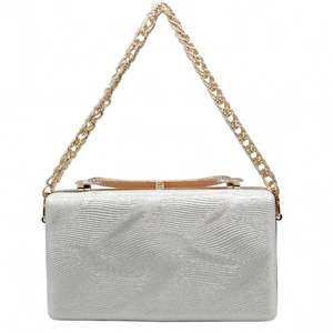 Detail of silver evening clutch featuring wavy texture and elegant gold twisted chain strap