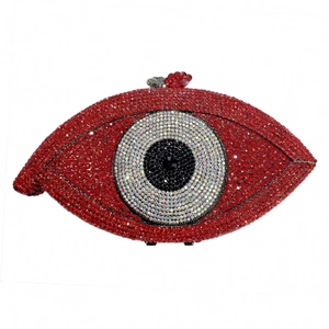 Detailed view of an eye-shaped evening clutch with red, white, and black rhinestones