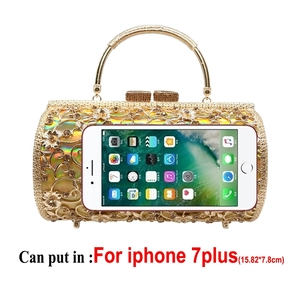 Macro detail of golden hollow floral evening bag showing large interior capacity for smartphone