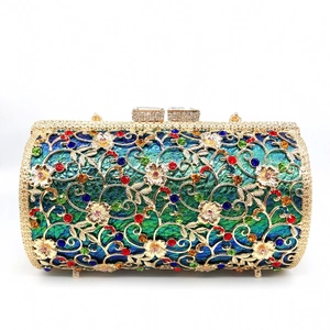 Close-up of hollow gold floral metal mesh with multi-colored crystals on evening clutch bag