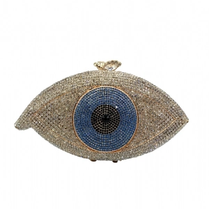 Detailed view of evil eye clutch bag with blue and white crystals and metal bow clasp
