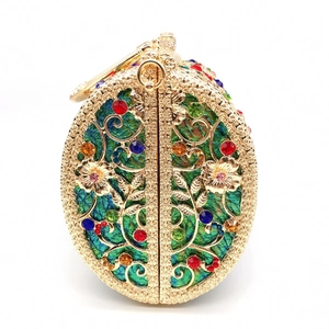 Detailed view of hollow metal evening bag with vibrant multicolor rhinestones and gold finish