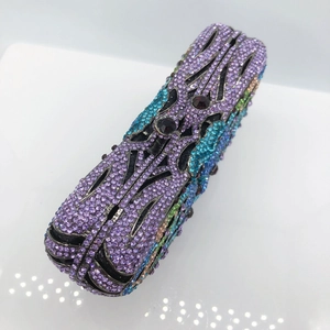 Detailed macro view of hollowed metal surface with sparkling crystals on evening clutch
