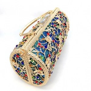 Detail of gold hollow evening bag with multi-color rhinestones and crystal handle