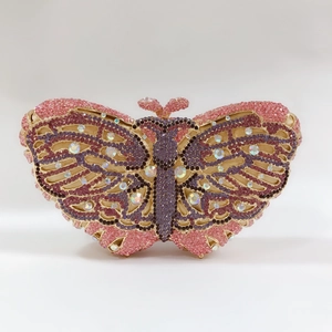 Detailed close-up of pink and purple crystal butterfly clutch bag with gold frame