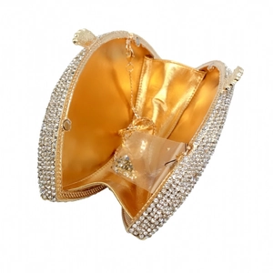 Detail view of gold luxury evening clutch with crystal rhinestones and metal chain strap