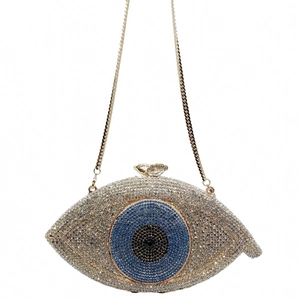 Close-up of sparkling evil eye evening clutch with crystals and gold crown clasp