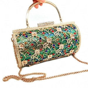 Macro detail of hollow metal evening bag with colorful rhinestones and gold top handle