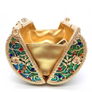 Macro detail of gold hollow-out evening clutch with multicolored rhinestones and satin lining