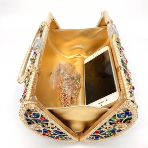 Open gold hollow clutch bag with rhinestones showing phone storage and chain