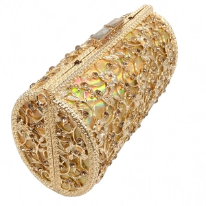Detailed macro view of golden filigree hollow dinner bag with champagne rhinestones