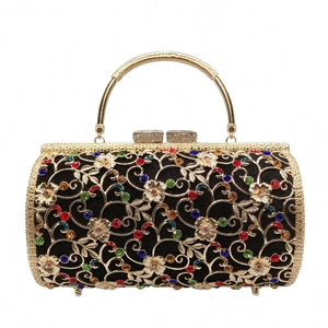 Detail of floral gold镂空metal design with vibrant rhinestones on luxury evening clutch