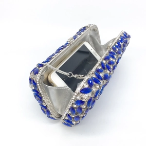 Silver evening clutch bag with blue rhinestones and interior space for smartphone