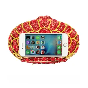 Macro detail of red crystal clutch bag showing capacity fit for a smartphone