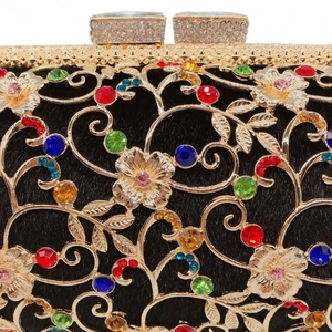 Detailed close-up of gold hollow metal晚宴包 featuring colorful rhinestones and floral patterns