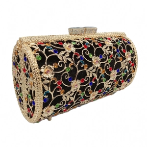 Detail of hollow metal evening clutch with colorful rhinestones and crystal clasp