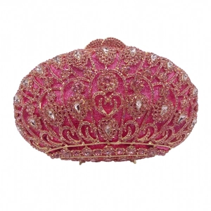 Detail of evening clutch bag with pink rhinestones and regal crown-like embellishments