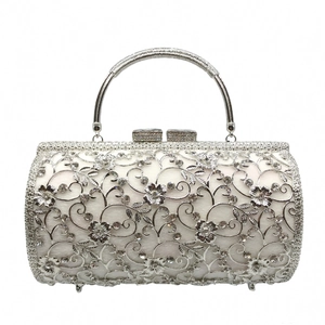 Detailed view of silver hollow-out metal clutch bag with rhinestones and crystal clasp