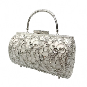 Detail of silver hollowed floral pattern evening bag with sparkling rhinestones