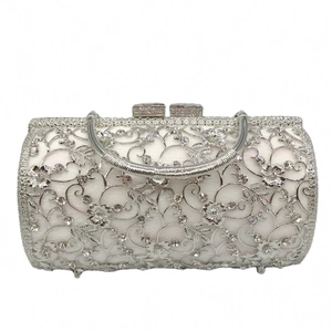 Detail view of silver hollowed floral evening bag with sparkling rhinestones and metal handle