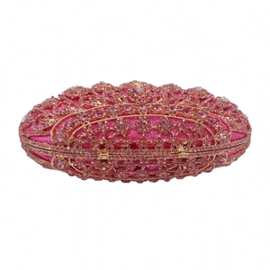 Detailed macro view of pink crystal rhinestones on a gold hollow evening clutch bag