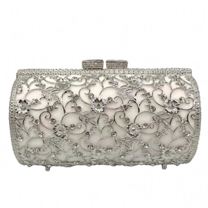 Detail of silver hollow floral metal frame evening bag with sparkling rhinestones