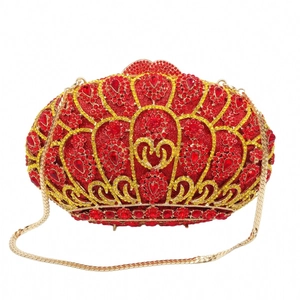 Luxurious red heart-shaped evening clutch bag with gold rhinestone accents and chain