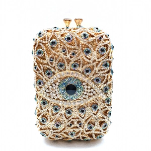 Luxuriöse Abendtasche mit funkelndem Kristall-Auge-Muster auf goldenem Metallgehäuse