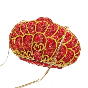 Detailed side view of luxury red crystal evening clutch with golden chain and wing pattern
