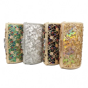 Detailed view of hollow out metal clutch bags featuring colorful rhinestones and floral patterns