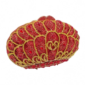 Detail of red and gold rhinestones on luxury evening clutch with radiant floral patterns