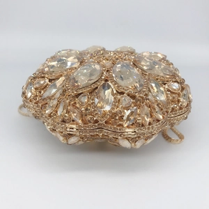 Luxurious gold oval evening clutch bag with sparkling crystals and metal chain
