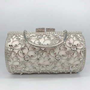 Detail of silver hollow metal evening clutch with rhinestones and sturdy metal feet
