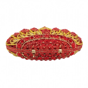 Macro detail of red rhinestones and gold floral metal frame on the evening clutch bag