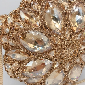 Luxurious champagne gold evening clutch with marquise-cut crystals and metal chain strap