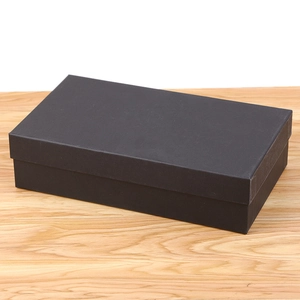 Minimalist matte black rectangular gift box for a diamond money clutch bag on wood