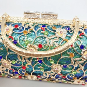 Detailed close-up of hollow gold floral metal mesh inlaid with colorful gemstones