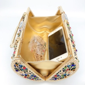 Top view of hollow gold evening clutch bag with colorful rhinestones and metal chain