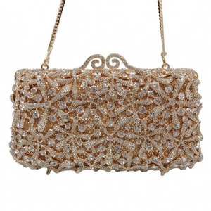 Detail of gold starfish clutch with white crystals, metal clasp, and fine chain strap
