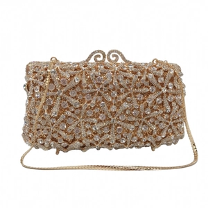 Detailed view of luxury gold evening clutch with starfish rhinestones and snake chain strap