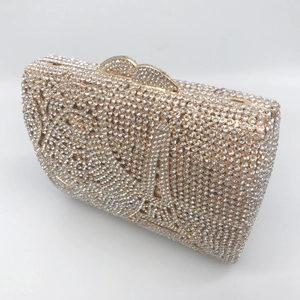 Luxury silver rhinestone clutch bag with gold heart-shaped clasp for formal dinner events
