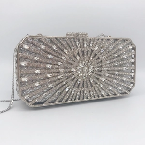 Elegant silver rectangle evening clutch with sunburst rhinestone pattern and chain strap