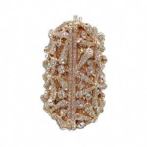Macro detail of luxury gold evening clutch featuring dense crystal embellishments