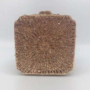Macro detail of gold metal evening clutch with radiating champagne rhinestone pattern